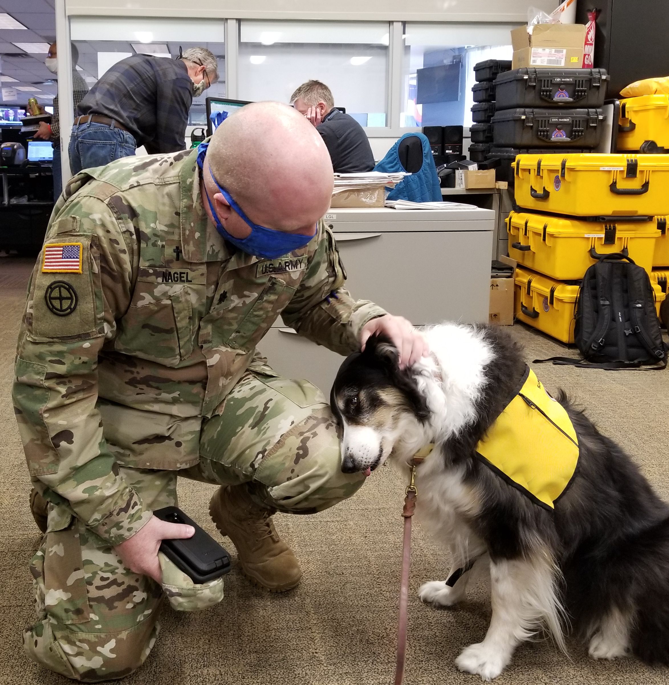 Members of the Colorado National Guard visit with a Pet Partners therapy dog during an AACR deployment