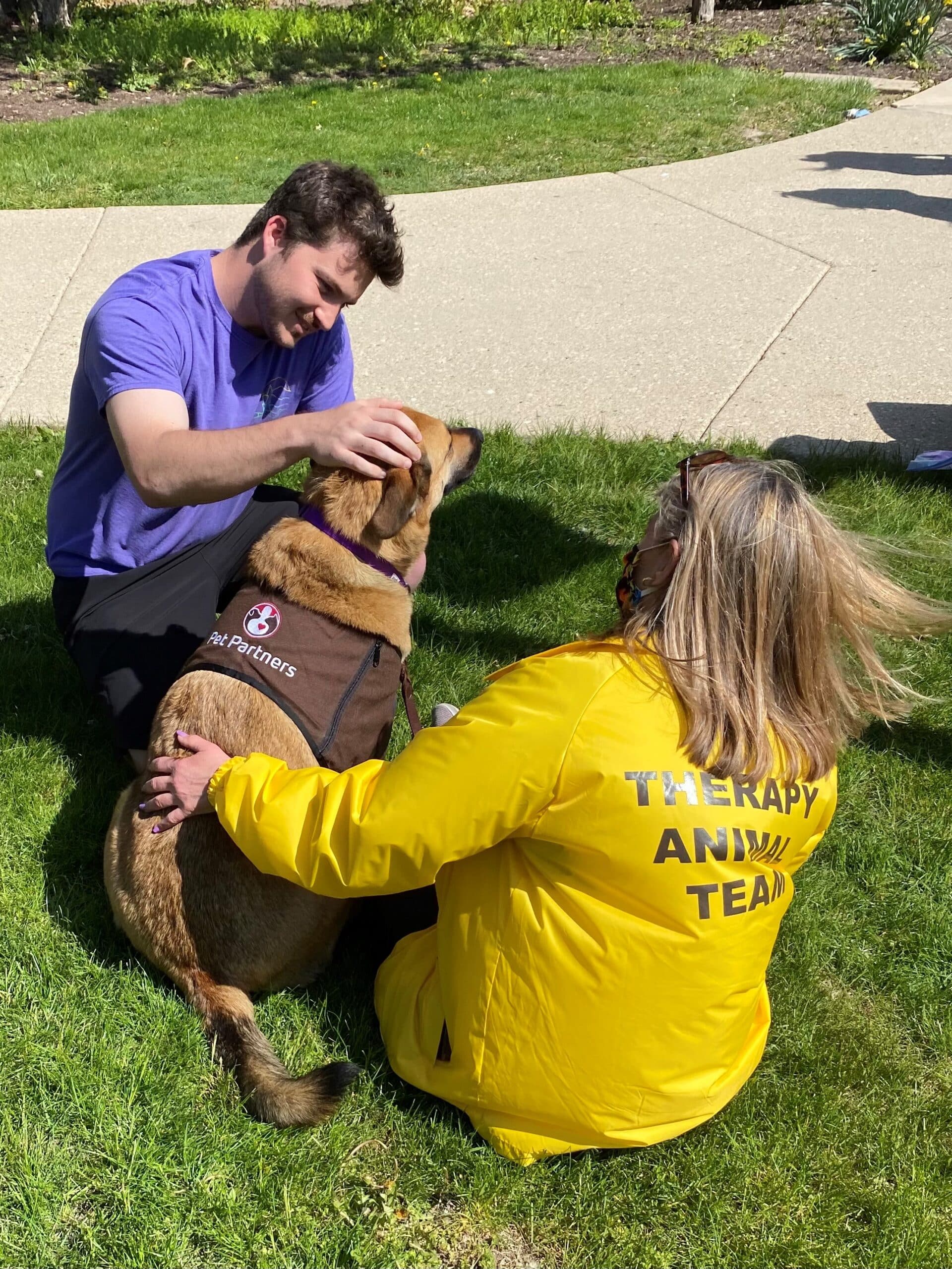 An AACR dog team provides comfort to a client.