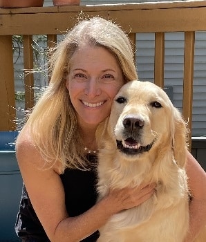 A blond woman hugs a golden retriever therapy dog. Photo provided by Jennifer Lager.