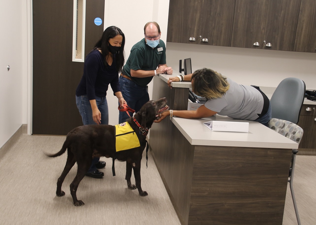 A Pet Partners therapy dog team making a workplace well-being visit.