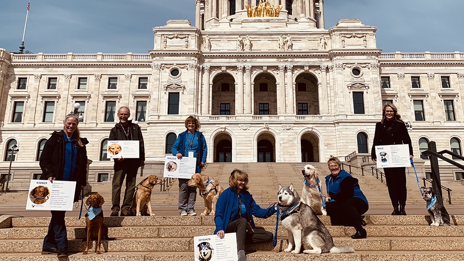 THerapy dog teams from North Star Therapy Animals pose on the steps after NTAD proclamation.