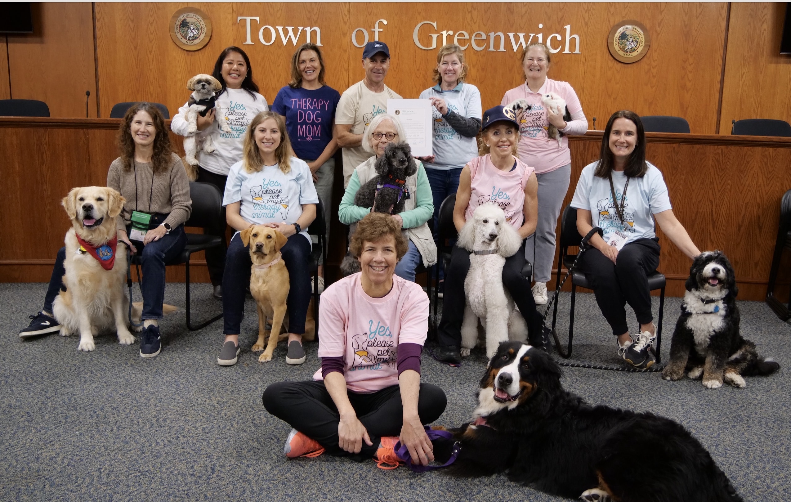 A group of Pet Partners handlers poses with their therapy dogs in Greenwich, CT.
