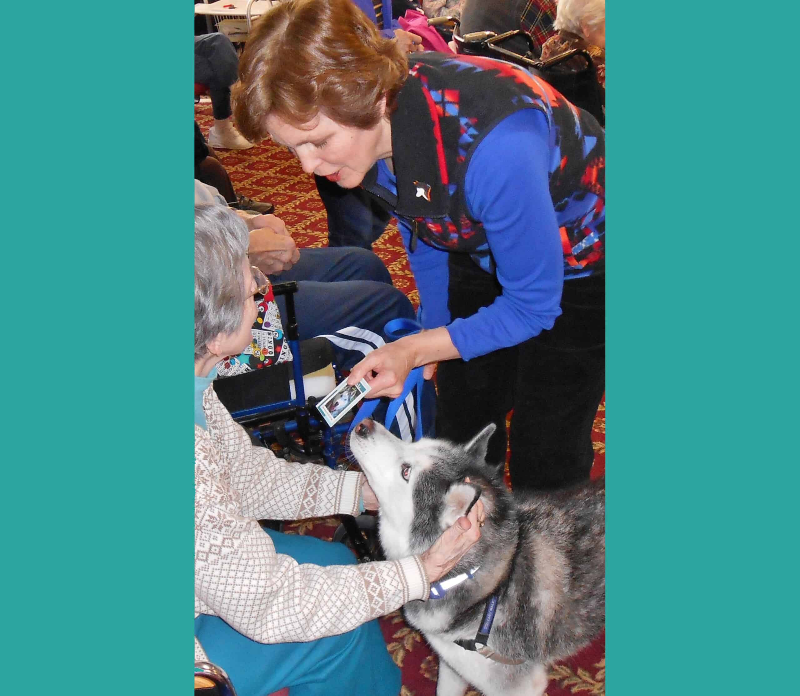 Patti Anderson and her therapy dog Neka visit a woman in a nursing home.