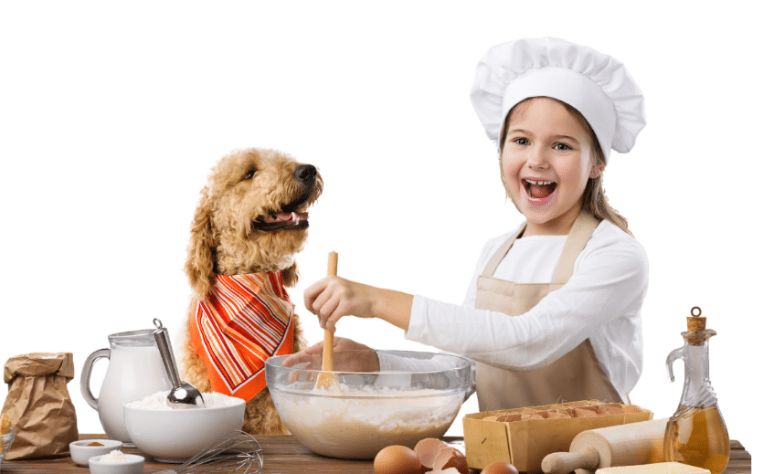 young girl baking with dog on kitchen counter