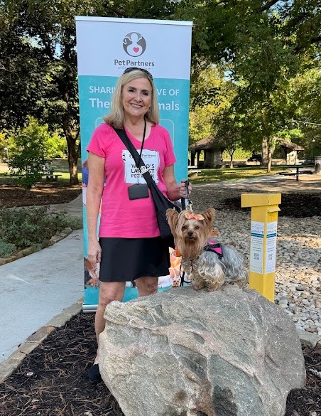 Longest walk participants - therapy dog resting beside its volunteer partner
